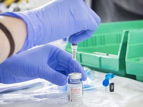 Drawing the Moderna COVID vaccine into a syringe