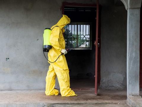 Ebola worker disinfecting
