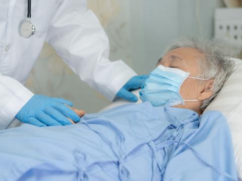 Elderly hospital patient wearing mask