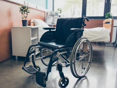 Empty wheelchair and hospital bed