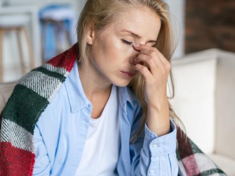 Exhausted woman draped in blanket