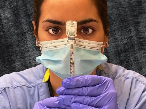 Pharmacist dosing the Pfizer COVID vaccine