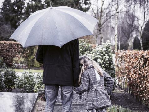 Father and daughter at graveside