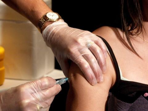 Girl receiving shot in arm