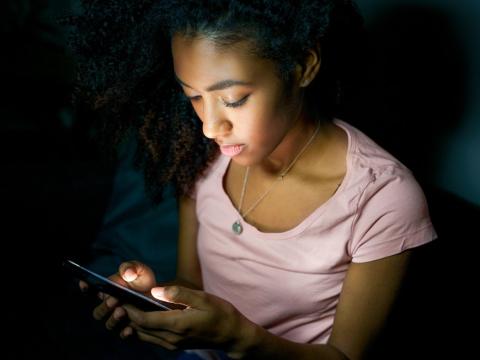 Girl on smartphone at night