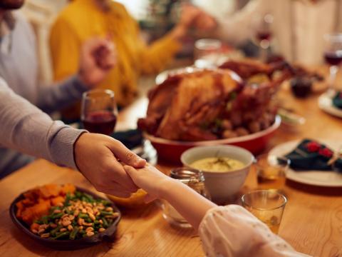 Family giving thanks at Thanksgiving