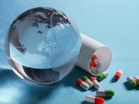Glass globe and spilled capsules