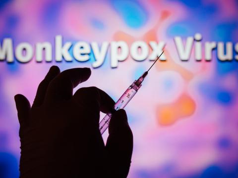 Hand holding monkeypox vaccine syringe
