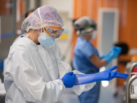 Healthcare worker putting on gloves