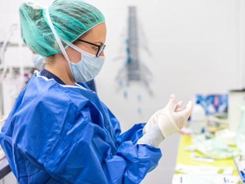 Healthcare worker putting on personal protective equipment