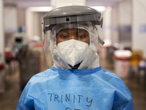 Healthcare worker wearing respirator, face shield