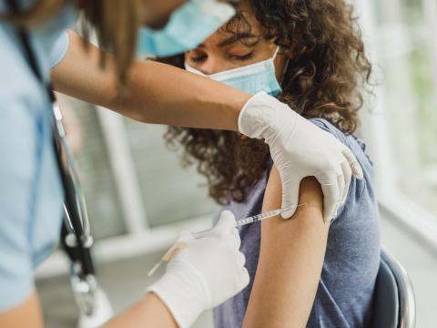 Teenage girl getting vaccinated