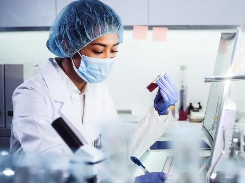 Lab researcher with sample