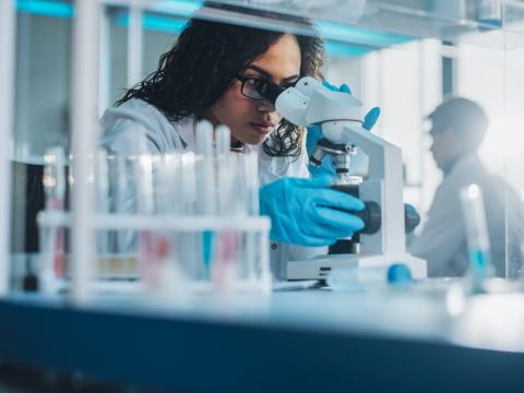 Lab scientist at microscope
