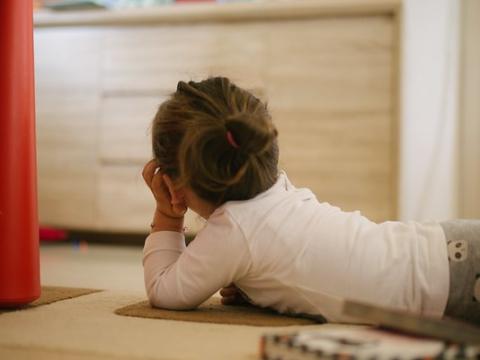 Little girl watching Mickey Mouse on TV