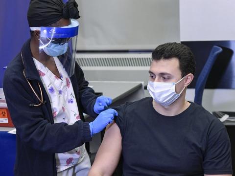 Man getting prepped for COVID vaccine