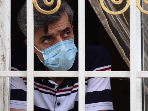 Man quarantined looking out window