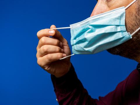 Man removing face mask