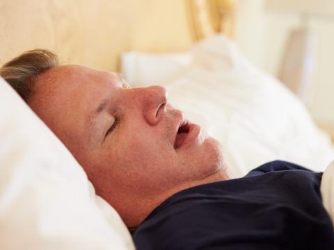 Man snoring in bed