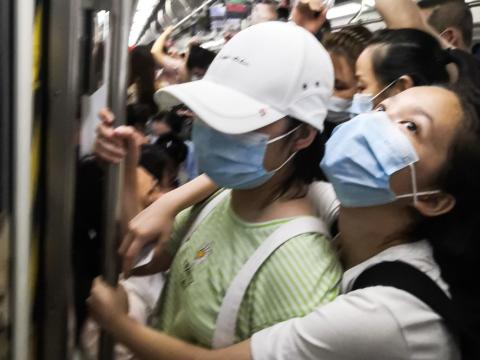 Masked people in a crowded subway