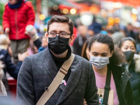 People wearing masks on busy street