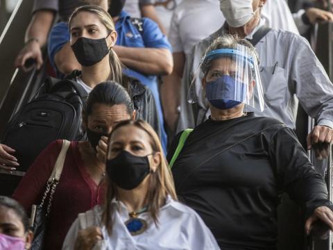 Masked Colombians on escalator