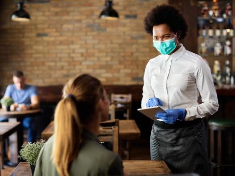 Masked waitress taking order