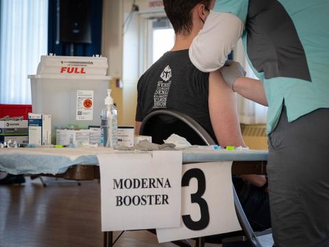 Moderna booster sign in vaccine clinic