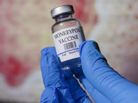Monkeypox vaccine vial in gloved hand