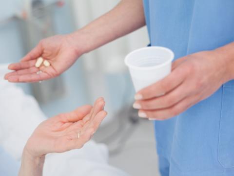 Nurse giving pills