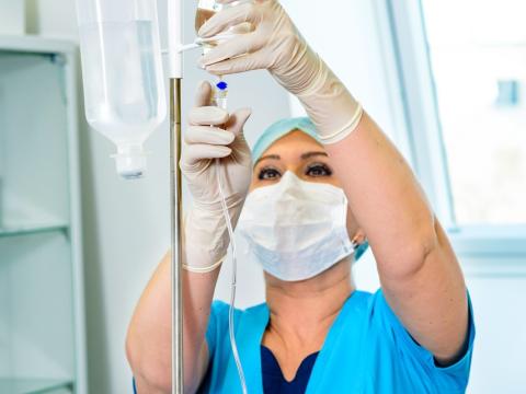 Nursing hanging an IV drip