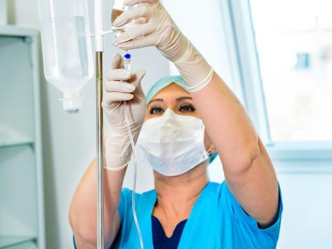 Nurse with IV stand