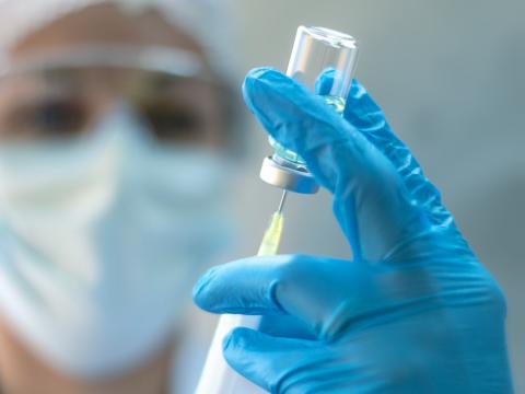 Nurse with vaccine vial and syringe