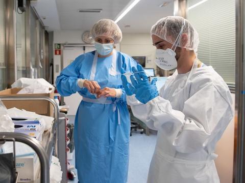 Nurses putting on protective equipment