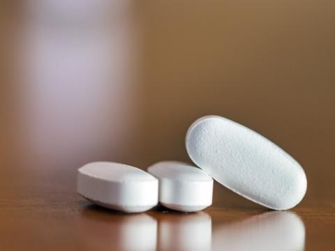 Three oblong white pills