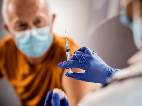 Older man about to get vaccinated