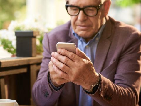 Older man holding smartphone