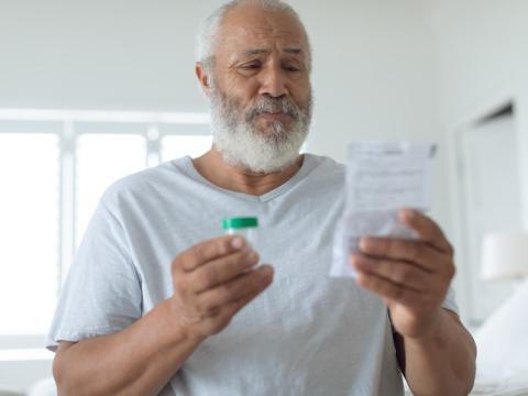 Older man reading prescription