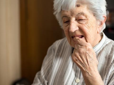 Older woman taking pill