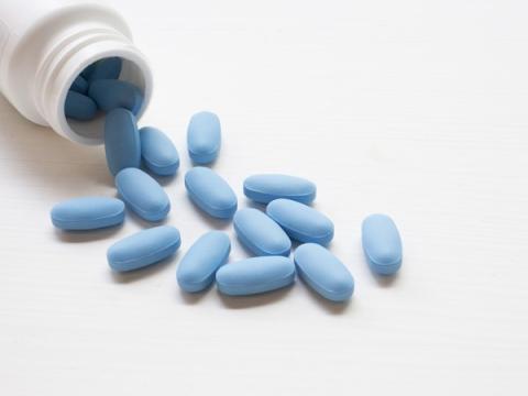 Oval blue pills and bottle