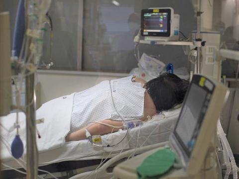Patient lying prone in hospital bed