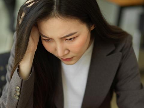 Pensive woman at laptop