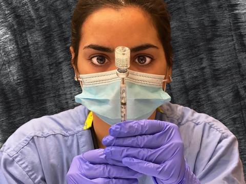 Pharmacist filling syringe