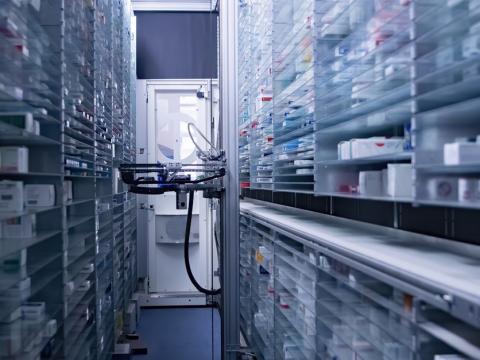 Pharmacy storage room with robot arm