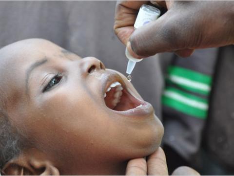 An African child is given oral polio vaccine.