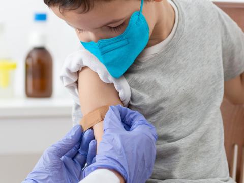 Post-vaccine bandage for young boy