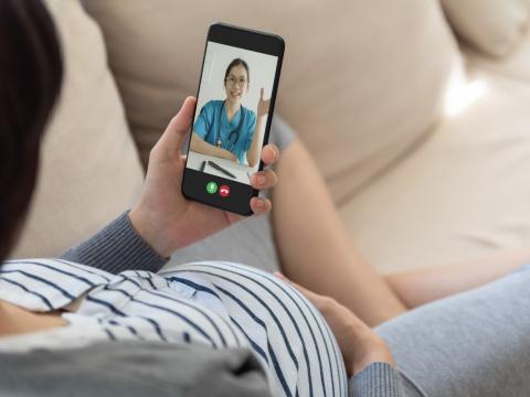 Pregnant woman consulting with doctor on phone