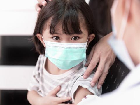 Preschool girl getting vaccinated