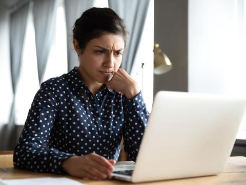 Puzzled woman at laptop