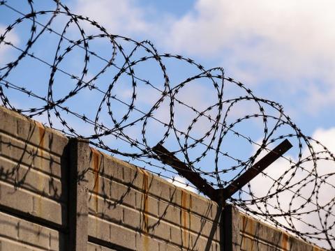 Razor wire on top of wall